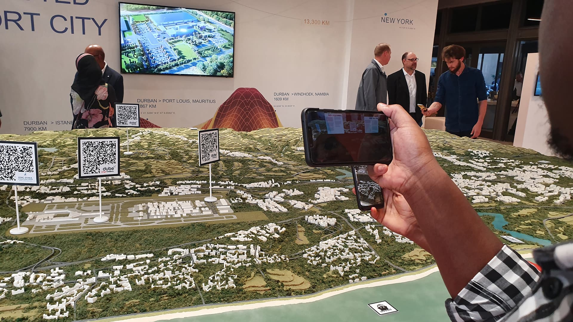 A visitor holding a phone over the Durban Aerotropolis scale model