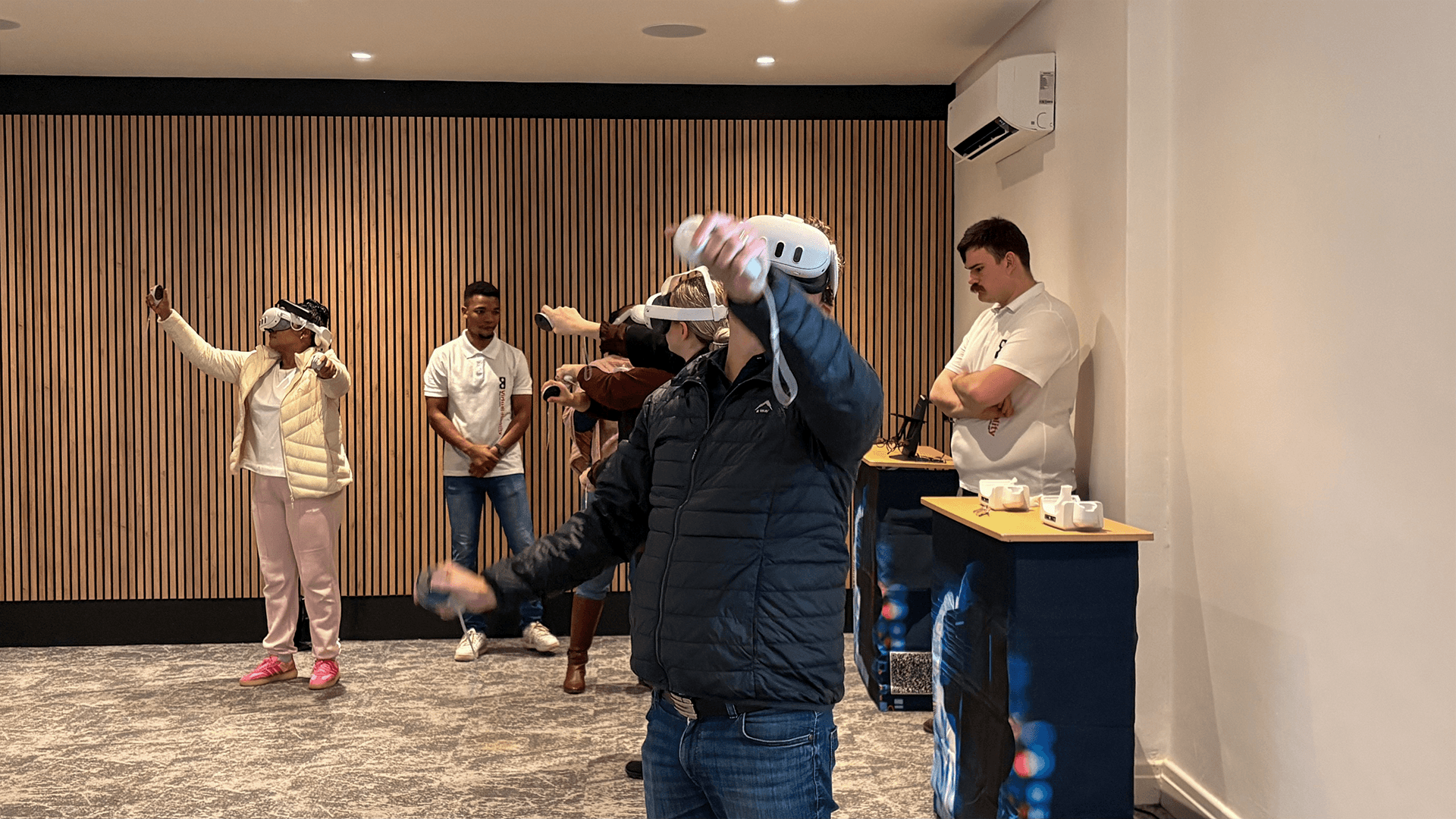 A group taking part in virtual reality games with event staff nearby