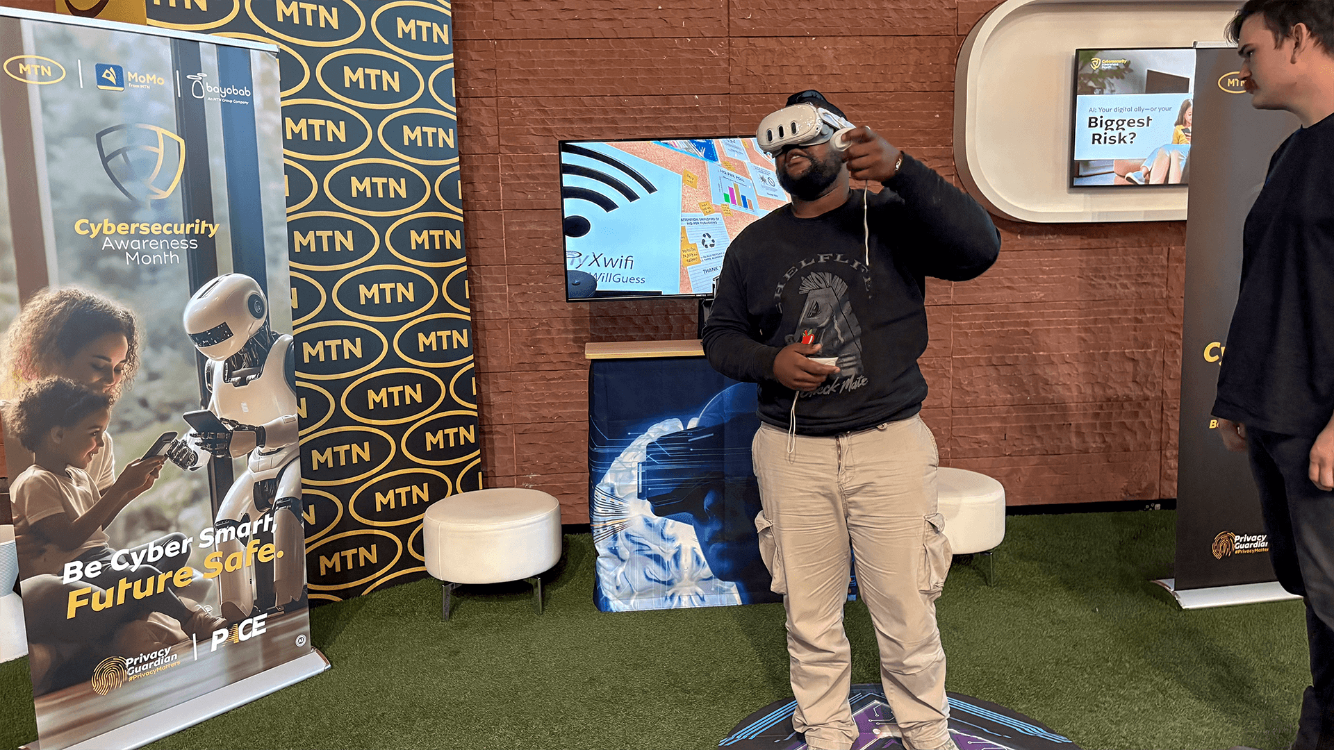 A guest trying a VR headset beside a spectator display