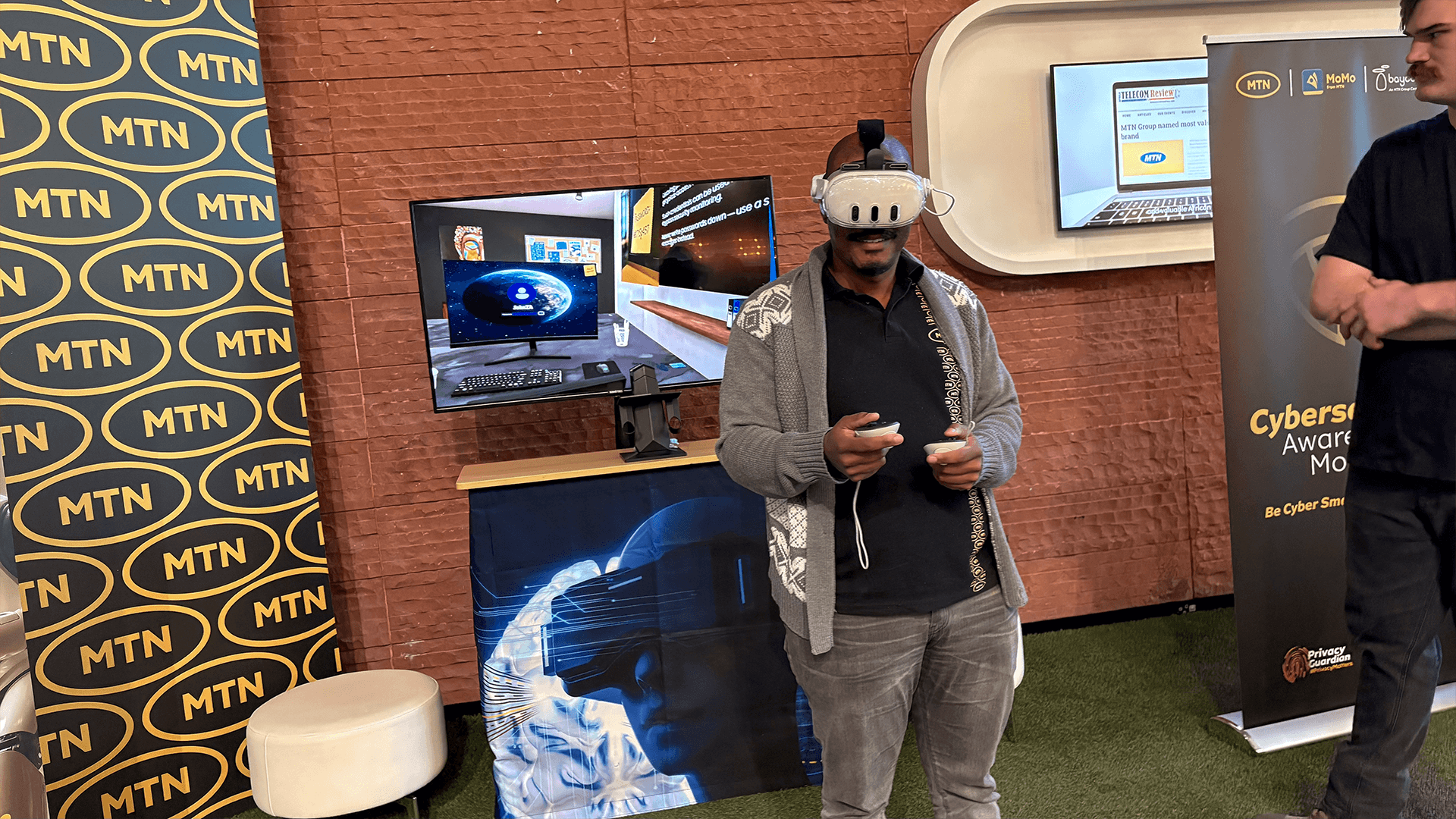 A suited guest exploring a virtual reality experience at a branded stand