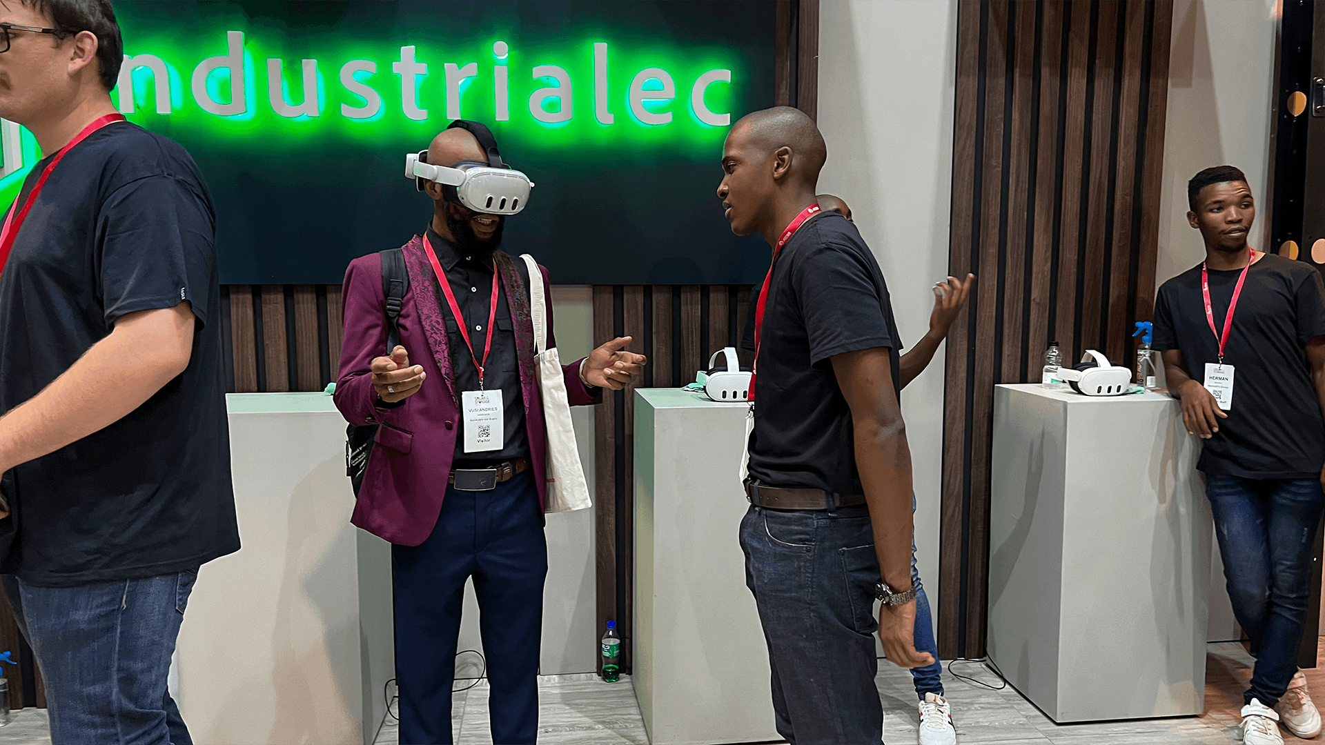 Visitors trying VR headsets at a conference exhibition stand