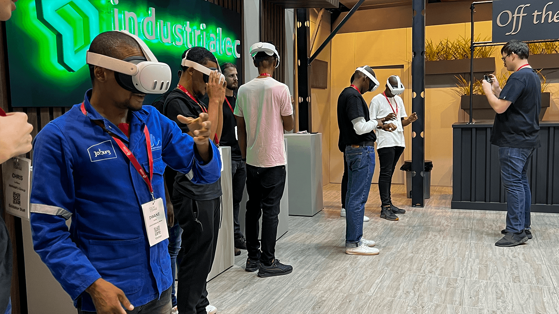A guest holding VR controllers during a conference demonstration