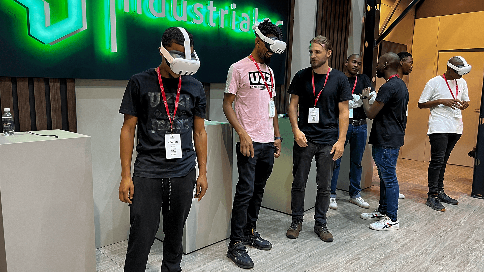 Attendees watching a virtual reality participant at an exhibition stand
