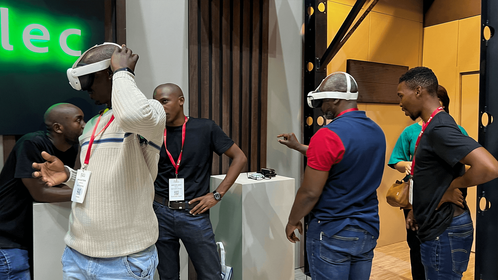 A VR participant reaching upward while staff and visitors watch