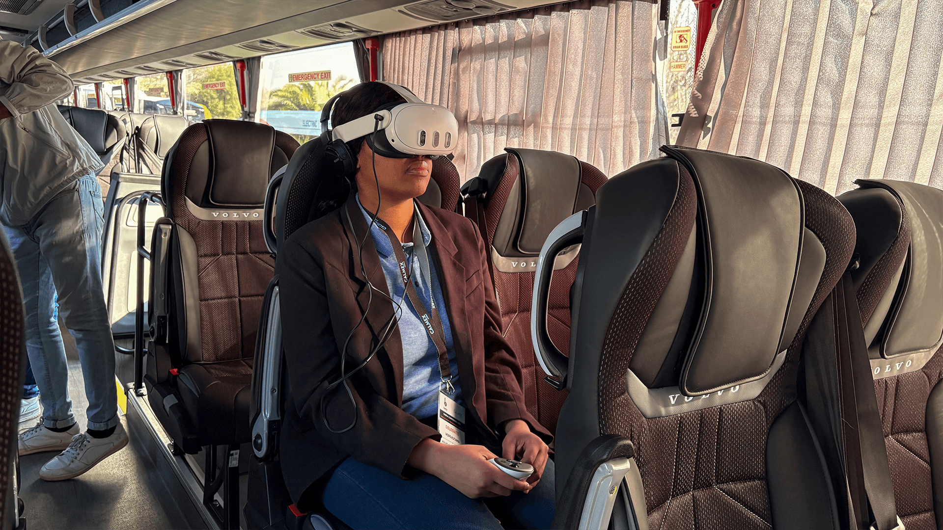 A seated coach passenger exploring a virtual reality experience