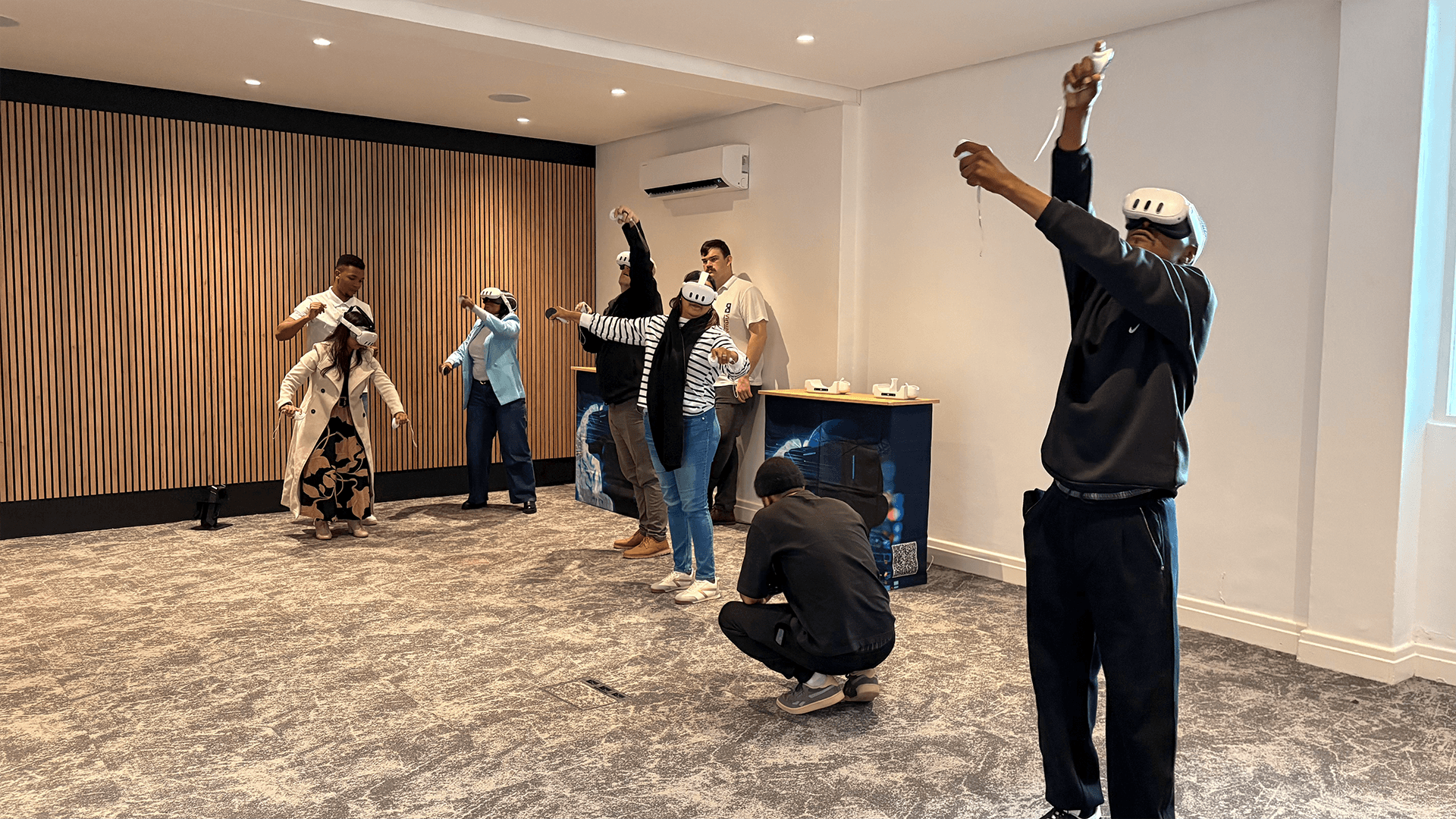 A VR participant reaching upward during a group activity