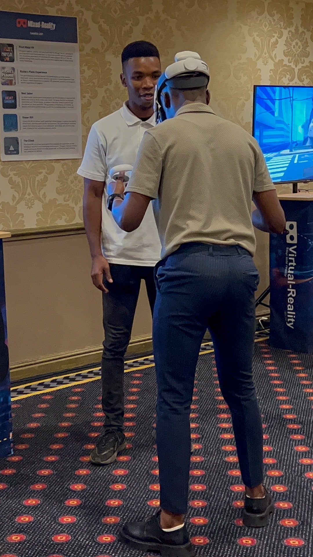 An event facilitator assisting a guest with a virtual reality experience