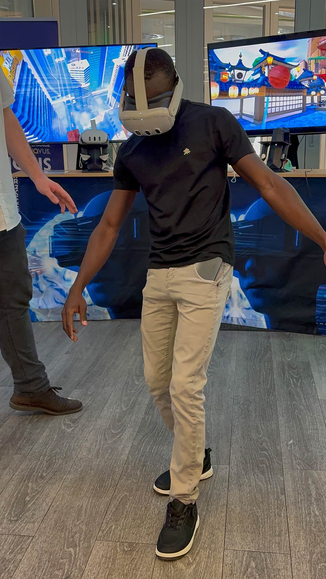 A VR participant leaning forward with arms extended at an event