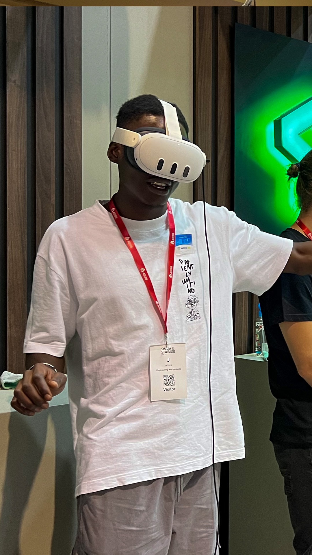 A guest in a white shirt using a VR headset during an event demonstration