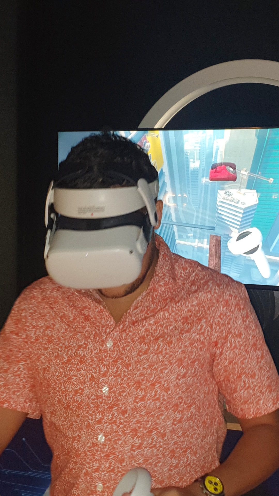 A guest in a patterned shirt trying a virtual reality headset