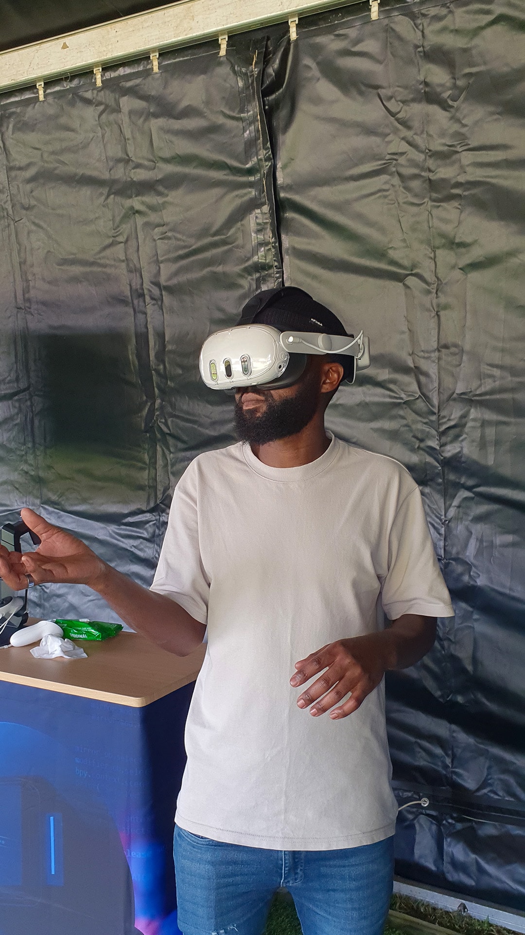 A guest wearing a VR headset and holding a controller at an exhibition