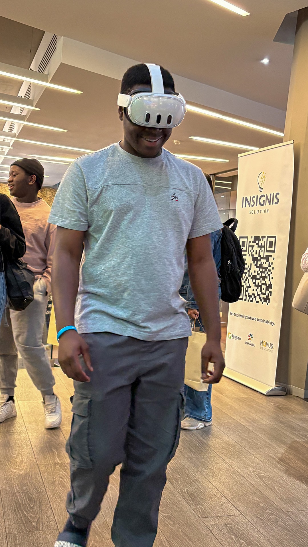 A participant trying a virtual reality headset in an indoor event space