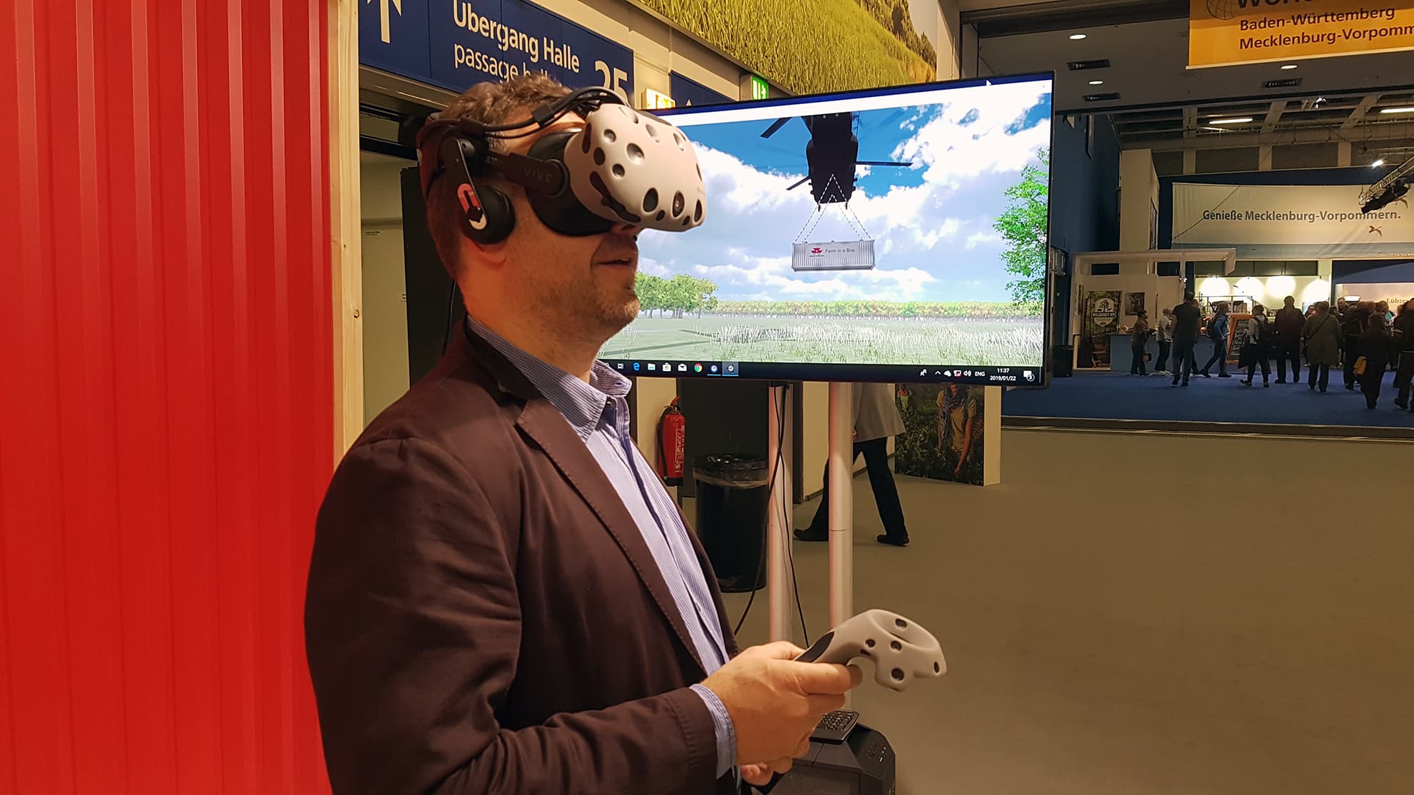 A guest using a virtual reality headset and controllers at a Mixed Reality activation